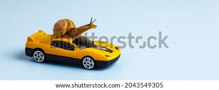Speedy snail like car racer. Concept of speed and success. Concept of fast taxi or delivery. Yellow race car on light blue background. Banner, copy space