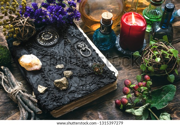 Spell book, magic potions and\
other various witchcraft accessories on the wizard table\
background.