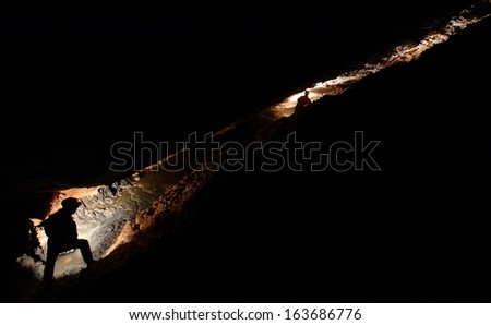 Spelunkers exploring an underground cave river