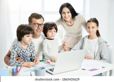 Spend Days With People You Love. Happy Latin Family With Children Spending Time Together At Home. Father Watching Cartoons Together With Kids While Using Laptop