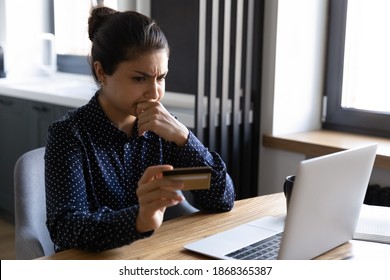 Spend Too Much. Shocked Upset Young Hindu Female Shopper Check Balance Of Credit Card Using Laptop Seeing Huge Debt. Frustrated Indian Lady Losing Money After Paying Online. Internet Scam Fraud Victim