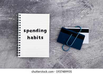 Spending Habits Text On Notepad With Payment Cards Next To It, Money And Consumer Behaviour Conceptual Image