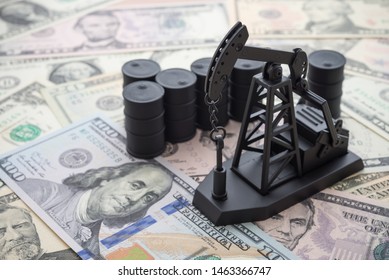 Spending Or Investment Of A Country's Revenues From Petroleum Exports Industry (Petrodollar). Oil Pump Jack And Barrels On US Dollar Banknotes. Concept Of Crude Oil Production, Petroleum Industry.