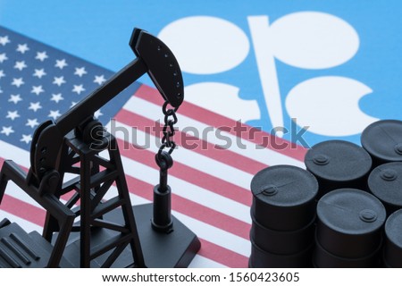 Spending or investment of a country's revenues from petroleum exports industry (Petrodollar). Oil pump jack on U.S. and OPEC flag background. Concept of U.S. crude oil production, petroleum industry.