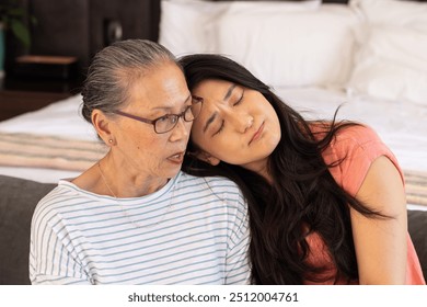 Spending quality time,  asian grandmother and granddaughter relaxing together indoors. family, bonding, multigenerational, relaxation, togetherness, caring - Powered by Shutterstock