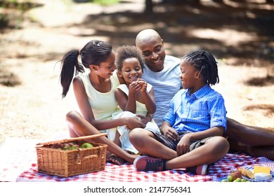 Spending Some Family Time Outdoors. Shot Of A Family Enjoying A Picnic In The Woods.