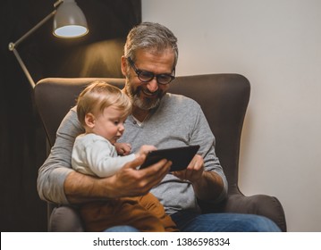 spending time with his grandson at home - Shutterstock ID 1386598334