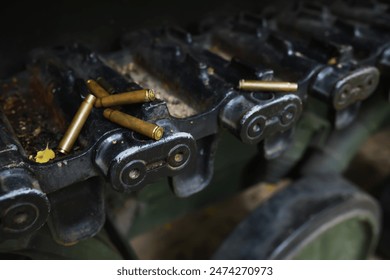 Spent Bullet Casings on Military Vehicle Track Mechanism in Close-up - Powered by Shutterstock