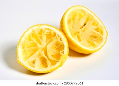 Spent lemon fruit shell after finished squeezing isolated on horizontal white background.