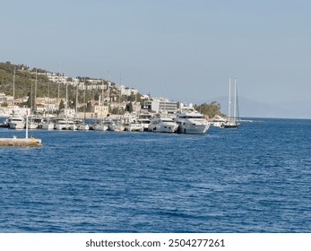 Spetses island, Greece. Yachts and sailing boats anchored at marina, cloudy sky - Powered by Shutterstock