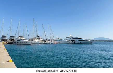 Spetses island, Greece. Yachts and sailing boats anchored at marina, cloudy sky - Powered by Shutterstock