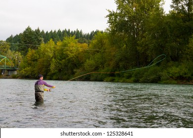 A spey casting fly fisherman swings flies for steelhead on the Willamette River in Oregon.
