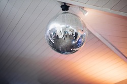 Silver and gold disco balls hang from the ceiling on New Years eve Holiday  Stock Photos