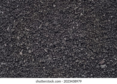 Spherical lumps of crushed ore concentrate close-up. Semi-finished product of metallurgical production of iron. Product of concentration of iron-bearing ores and subsequent pelletizing and roasting.