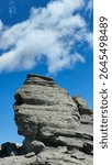 The Sphinx of Carpathians in Bucegi Mountains, Romania. The iconic silhouette of the Bucegi Sphinx, captured in the warm afternoon light, clearly reveals its human-like shape sculpted by nature.