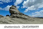 The Sphinx of Carpathians in Bucegi Mountains, Romania. The iconic silhouette of the Bucegi Sphinx, captured in the warm afternoon light, clearly reveals its human-like shape sculpted by nature.