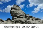 The Sphinx of Carpathians in Bucegi Mountains, Romania. The iconic silhouette of the Bucegi Sphinx, captured in the warm afternoon light, clearly reveals its human-like shape sculpted by nature.