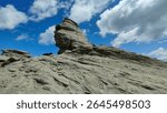 The Sphinx of Carpathians in Bucegi Mountains, Romania. The iconic silhouette of the Bucegi Sphinx, captured in the warm afternoon light, clearly reveals its human-like shape sculpted by nature.
