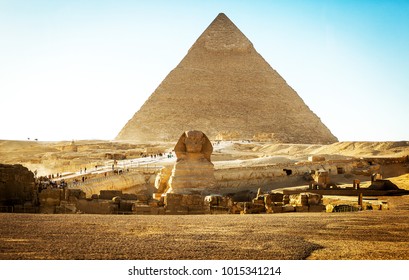 Sphinx With Pyramids At Sunset In Egypt