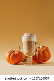 Spice Pumpkin Latte In Glass With Pumpkins On Yellow Background, Copy Space, Top View