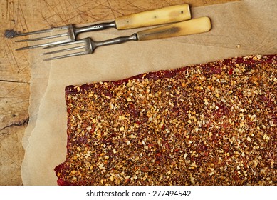 Spice Rubbed Raw  Beef, Making Jerky Meat On Wooden Backdrop With Vintage Curving Fork