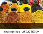 Spice sales at the Egyptian Bazaar in Istanbul, Turkey: a stall with piles of mixed spices for cooking, as well as ground chili, paprika, turmeric, smoked chili, cinnamon, nutmeg and anise.