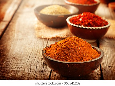 Spice. Various Spices over Wooden Background. Saffron, turmeric, curry in bowls on wooden table - Powered by Shutterstock