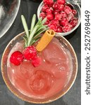 Spiced Cranberry Paloma with sugared cranberries cinnamon and rosemary