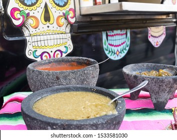 Spiced red tomato salsa and spiced green salsa for seasoning traditional Mexican food at a street food market, selective focus. Green jalapeno spicy dipping sauce and red peppers tomato spicy chili - Powered by Shutterstock