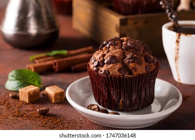 Spices, coffee and chocolate cupcakes in wooden box, close up