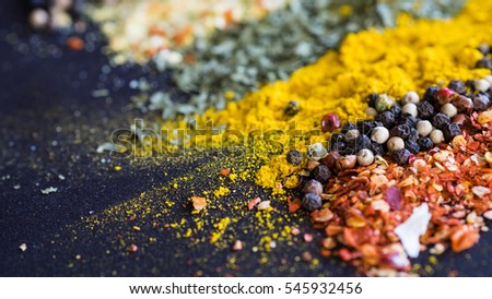 Spices and herbs on a black background