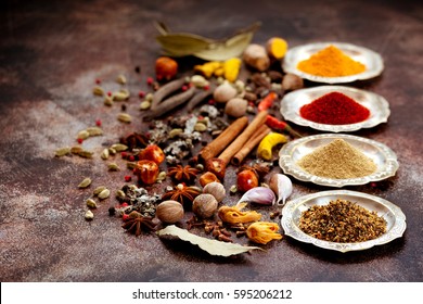 Spices and herbs on old kitchen table. Food and cuisine ingredients.