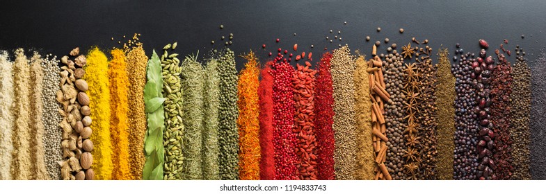 Spices And Herbs For Website Headers. Seasoning Scattered On Black Table, Background For Packing With Food.