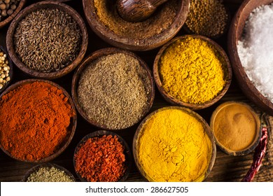 Spices and herbs in wooden bowls - Powered by Shutterstock