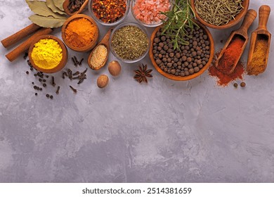 Spices and herbs in wooden spoons and bowls over light gray background,overhead flat lay - Powered by Shutterstock