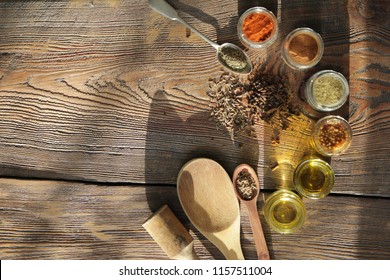 Spices, mustard, sunflower oil, cinnamon, red pepper and ginger in the kitchen on a wooden background
 - Shutterstock ID 1157511004