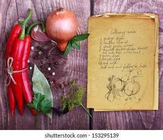 Spices And Old Recipe Book On Wooden Background.