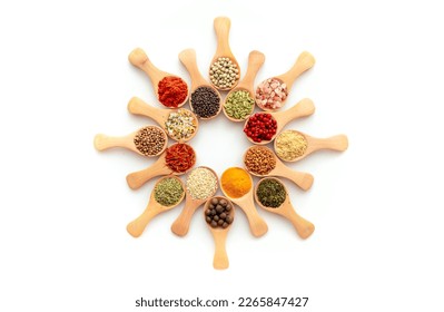 Spices pattern on a white background. A set of spices from India. Decoration design. Various spices, peppers and herbs close-up top view. A set of peppers and spices for cooking.