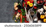 Spices , peppers, garlik, tomatos, mushrooms on dark background. Ingredient for cooking. Top view