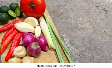 Spices or Rempah-rempah, lemongrass, tomato, chilies, garlic, shallots, lime and candlenuts as spices for Indonesian cooking. Indonesian spices on a wooden board - Powered by Shutterstock