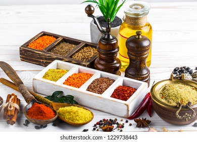 Spices and seasonings on the kitchen table on a white background - Shutterstock ID 1229738443