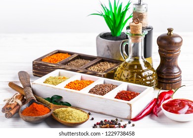 Spices and seasonings on the kitchen table on a white background - Shutterstock ID 1229738458