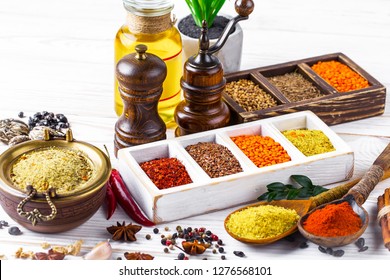 Spices and seasonings on the kitchen table on the old background - Shutterstock ID 1276568101