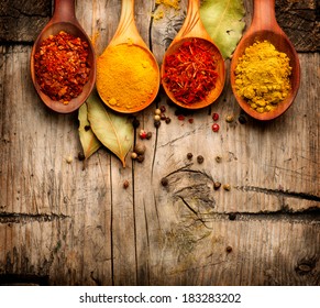 Spices. Spice over Wood. Herbs. Curry, Saffron, turmeric, cinnamon and other over wooden background - Powered by Shutterstock