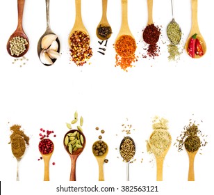 Spices in spoons isolated on white background. Top view.
