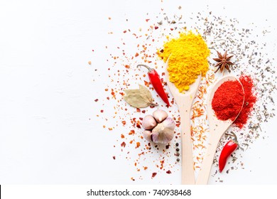 Spices in spoons and scattered on a white background with space for text - Powered by Shutterstock