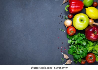 Spices, vegetables and fruits on dark stone background. Copy space for text, horizontal composition. Vegan food, healthy eating, food background concept - Powered by Shutterstock