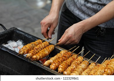 Spicy Barbecued Tofu Kebabs Being Prepared By Street Food Vendor In Chinese Market