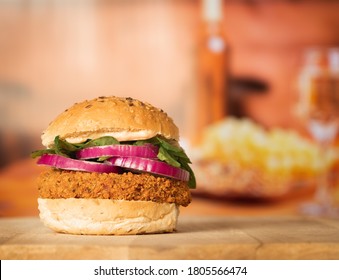 A Spicy Bean Burger On A Seeded Bun With Spinach And Red Onion In A Restaurant Setting