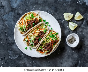 Spicy Beef And Cabbage, Carrots Pickled Salad Tacos On Dark Background, Top View